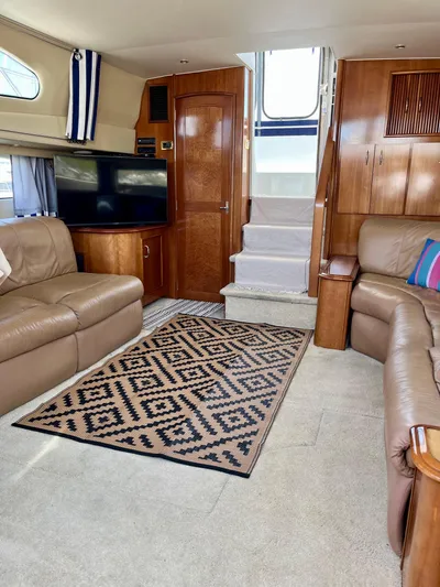 One In A Million Yacht Photos Pics Interior of a 2005 Carver 444 yacht with leather seating and patterned rug.