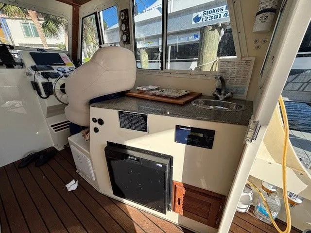 Rhode Waves Yacht Photos Pics Interior of 2018 Eastern 27 Islander Hardback with helm and kitchenette.
