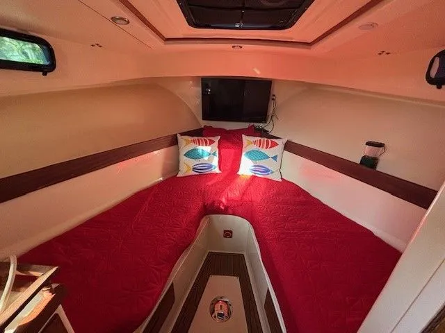 Rhode Waves Yacht Photos Pics Interior of a 2018 Eastern 27 Islander Hardback with red bedding.