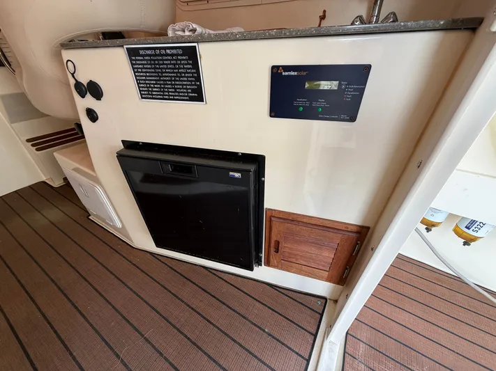Rhode Waves Yacht Photos Pics Interior of 2018 Eastern 27 Islander Hardback with fridge and solar panel controls.
