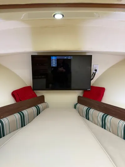 Rhode Waves Yacht Photos Pics Interior of 2018 Eastern 27 Islander Hardback with TV and seating area.