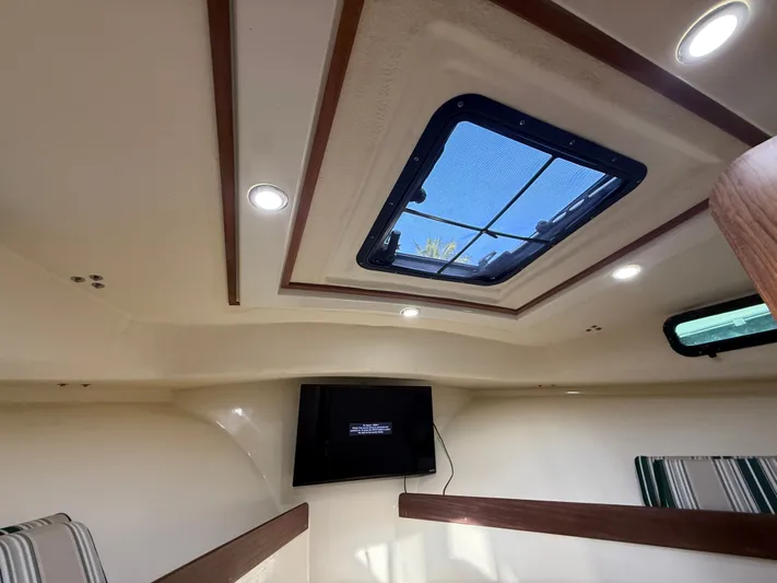 Rhode Waves Yacht Photos Pics Interior of 2018 Eastern 27 Islander Hardback with skylight and TV.
