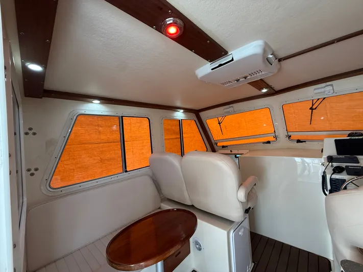 Rhode Waves Yacht Photos Pics Interior of a 2018 Eastern 27 Islander Hardback boat with seating area.