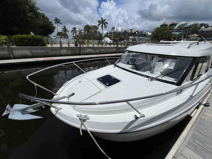  Yacht Photos Pics 2025 Beneteau Antares 8 docked, showcasing sleek design and modern features.