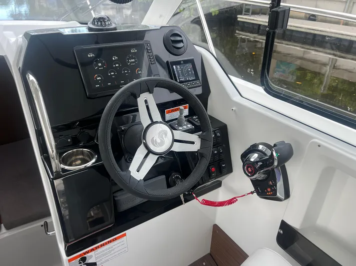  Yacht Photos Pics 2025 Beneteau Antares 8 helm with modern controls and navigation instruments.