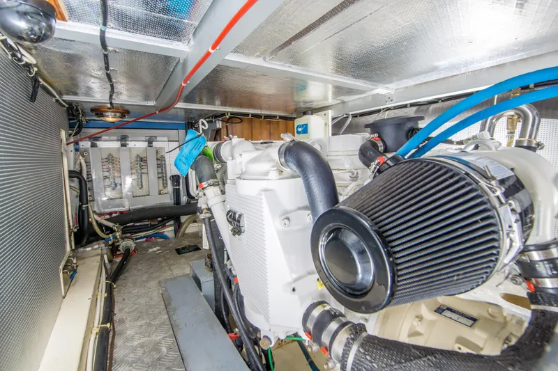 Papagayo Yacht Photos Pics Engine room of 2008 North Pacific 43 Pilothouse with visible machinery and wiring.