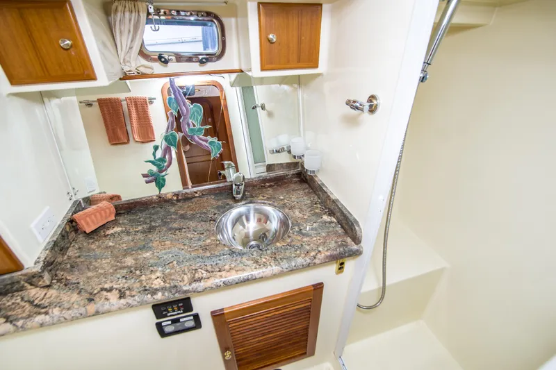 Papagayo Yacht Photos Pics 2008 North Pacific 43 Pilothouse bathroom with granite countertop and stainless steel sink.