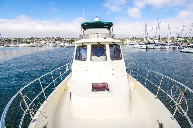Papagayo Yacht Photos Pics 2008 North Pacific 43 Pilothouse yacht in marina, surrounded by sailboats under blue sky.