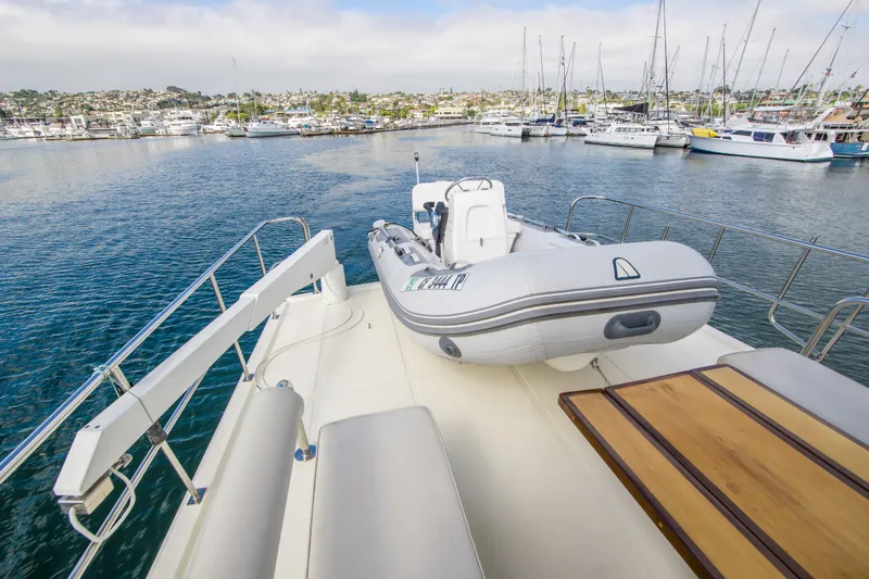 Papagayo Yacht Photos Pics 2008 North Pacific 43 Pilothouse yacht with inflatable boat on deck, docked in marina.