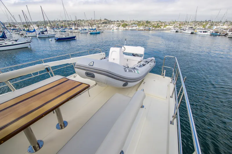 Papagayo Yacht Photos Pics 2008 North Pacific 43 Pilothouse yacht deck with tender, overlooking marina.