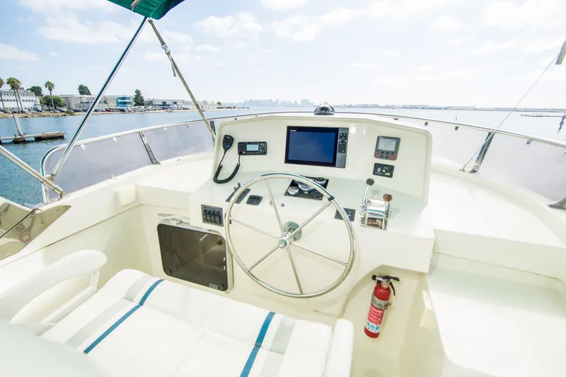 Papagayo Yacht Photos Pics Pilothouse of 2008 North Pacific 43, featuring steering wheel and navigation equipment.