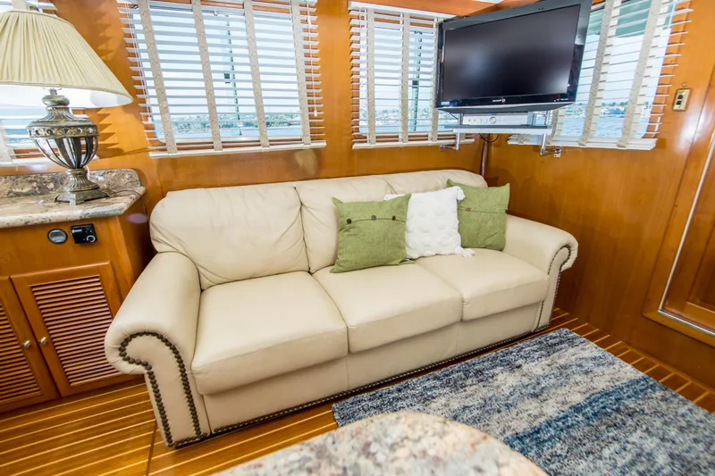 Papagayo Yacht Photos Pics Luxurious interior of 2008 North Pacific 43 Pilothouse with beige sofa and TV.