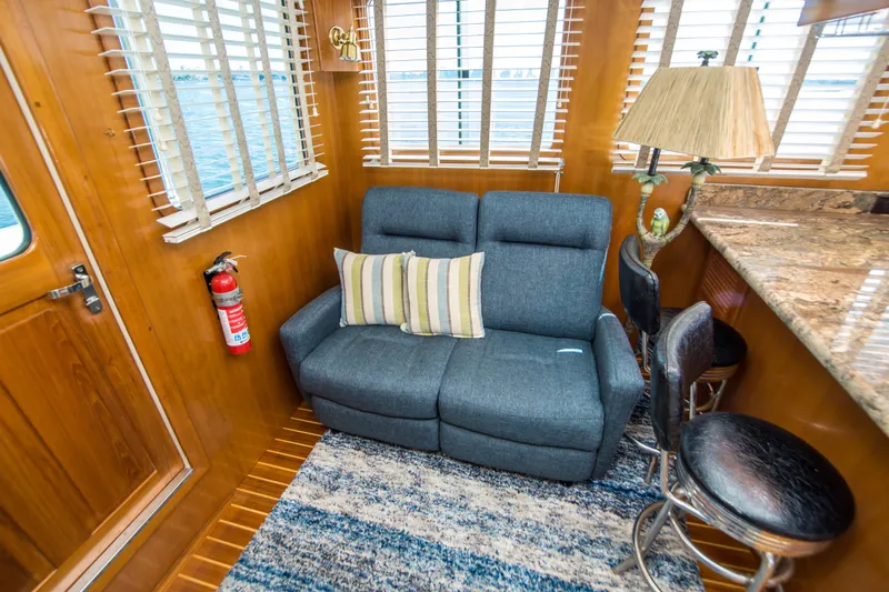 Papagayo Yacht Photos Pics Cozy interior of 2008 North Pacific 43 Pilothouse with sofa, bar stools, and nautical decor.