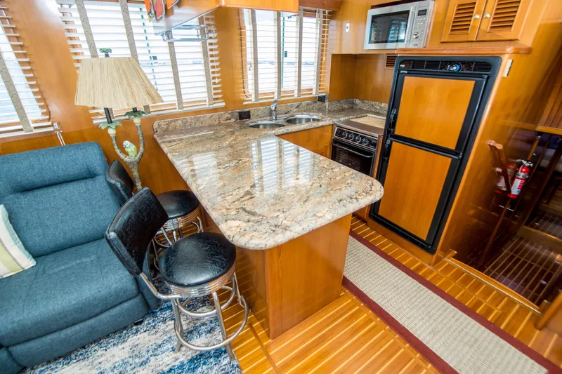 Papagayo Yacht Photos Pics Luxurious 2008 North Pacific 43 Pilothouse interior with modern kitchen and seating area.