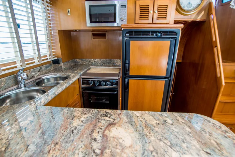 Papagayo Yacht Photos Pics Luxurious kitchen in 2008 North Pacific 43 Pilothouse yacht with granite countertops and modern appliances.