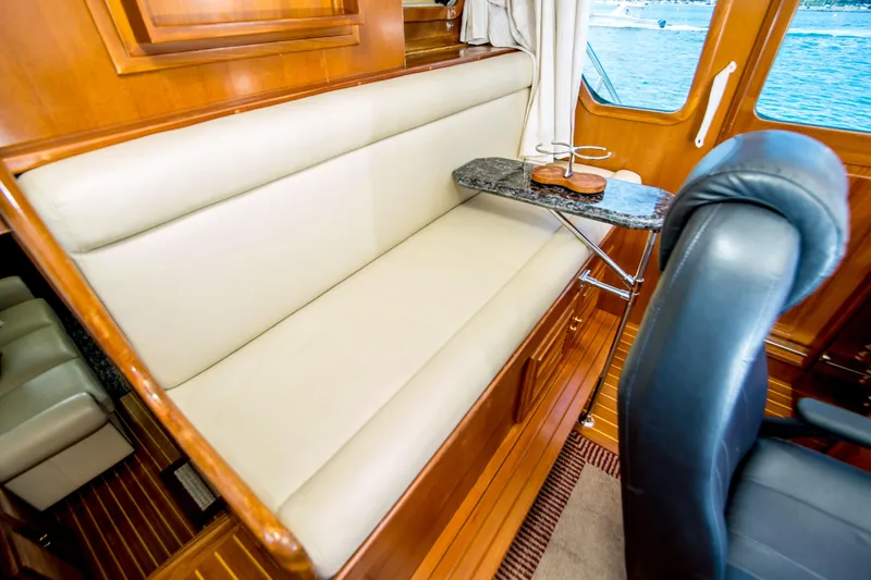 Papagayo Yacht Photos Pics Luxurious interior of 2008 North Pacific 43 Pilothouse with leather seating and wooden accents.