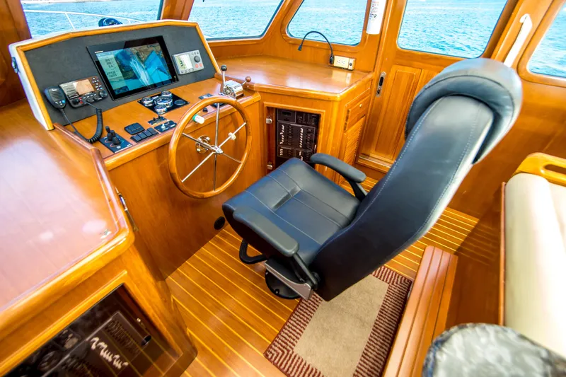 Papagayo Yacht Photos Pics Pilothouse interior of 2008 North Pacific 43, featuring navigation equipment and captain's chair.