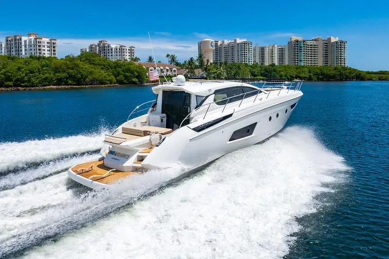 Endurance Yacht Photos Pics Azimut Atlantis 50 yacht cruising on water, 2016 model, with cityscape in background.