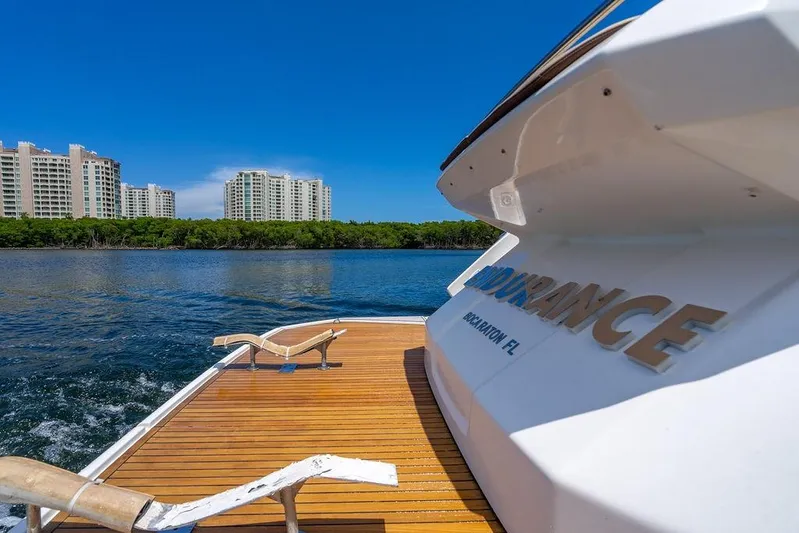 Endurance Yacht Photos Pics 2016 Azimut Atlantis 50 yacht on water, cityscape in background, clear blue sky.