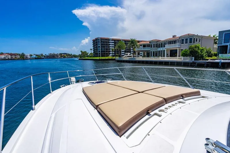 Endurance Yacht Photos Pics Luxurious 2016 Azimut Atlantis 50 yacht cruising near waterfront homes under a clear blue sky.