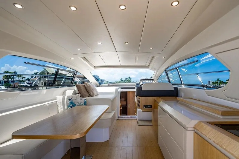Endurance Yacht Photos Pics Luxurious interior of 2016 Azimut Atlantis 50 yacht with elegant seating and panoramic windows.
