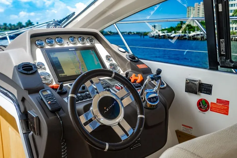 Endurance Yacht Photos Pics Cockpit of 2016 Azimut Atlantis 50 yacht with navigation controls and steering wheel.
