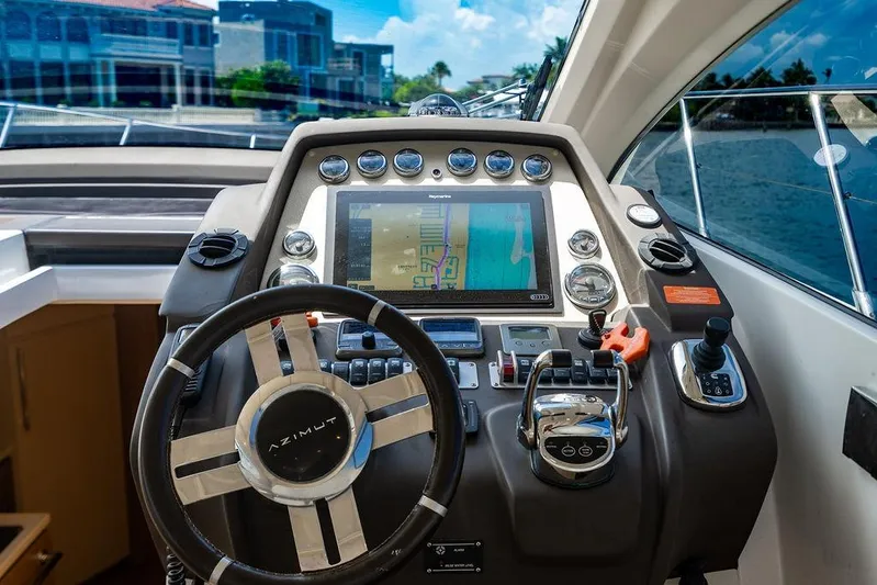 Endurance Yacht Photos Pics Cockpit of 2016 Azimut Atlantis 50 yacht with navigation controls and steering wheel.