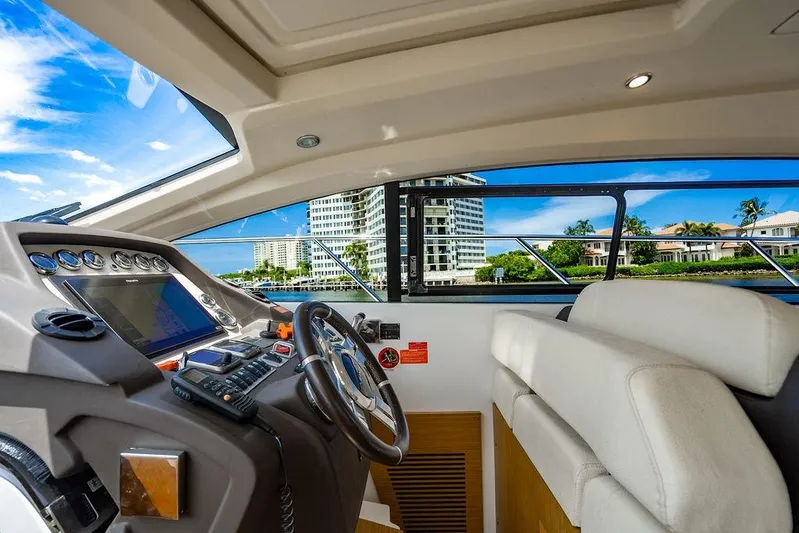 Endurance Yacht Photos Pics Interior view of 2016 Azimut Atlantis 50 yacht cockpit with modern controls and scenic window view.