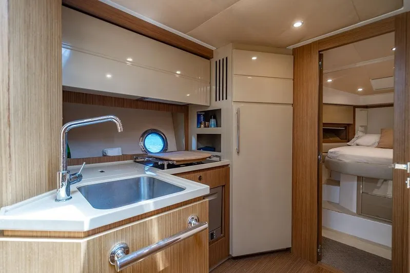 Endurance Yacht Photos Pics Luxurious interior of 2016 Azimut Atlantis 50 yacht featuring modern kitchen and cozy bedroom.