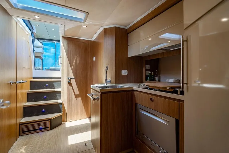 Endurance Yacht Photos Pics Luxurious interior of 2016 Azimut Atlantis 50 yacht featuring modern kitchen and staircase.