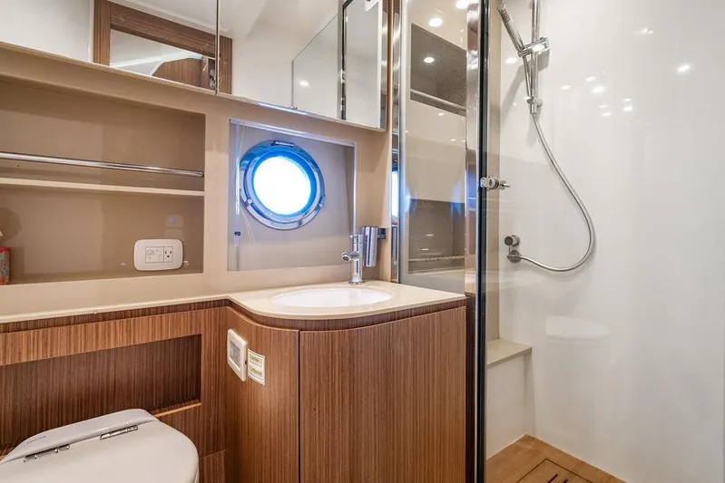 Endurance Yacht Photos Pics Luxurious bathroom in 2016 Azimut Atlantis 50 yacht with modern fixtures and porthole window.