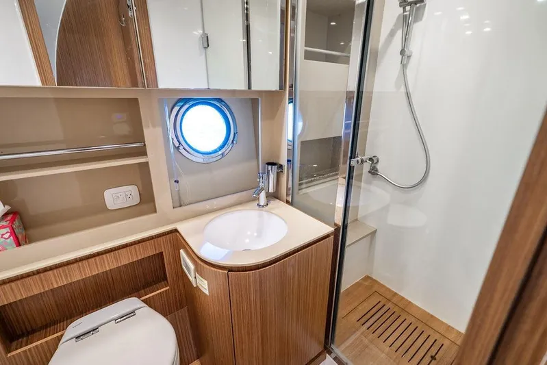 Endurance Yacht Photos Pics Luxurious bathroom in 2016 Azimut Atlantis 50 yacht with modern fixtures and porthole window.