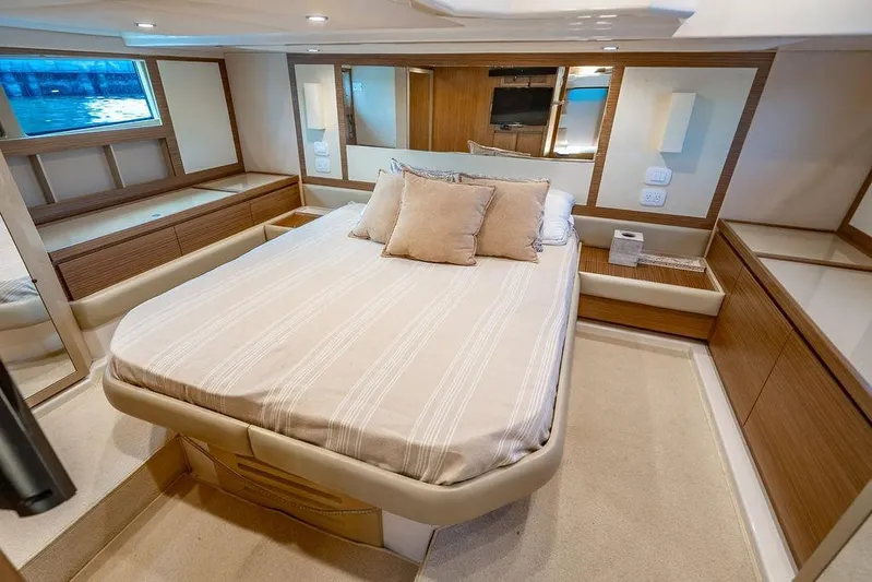Endurance Yacht Photos Pics Luxurious bedroom interior of 2016 Azimut Atlantis 50 yacht with elegant wood finishes.