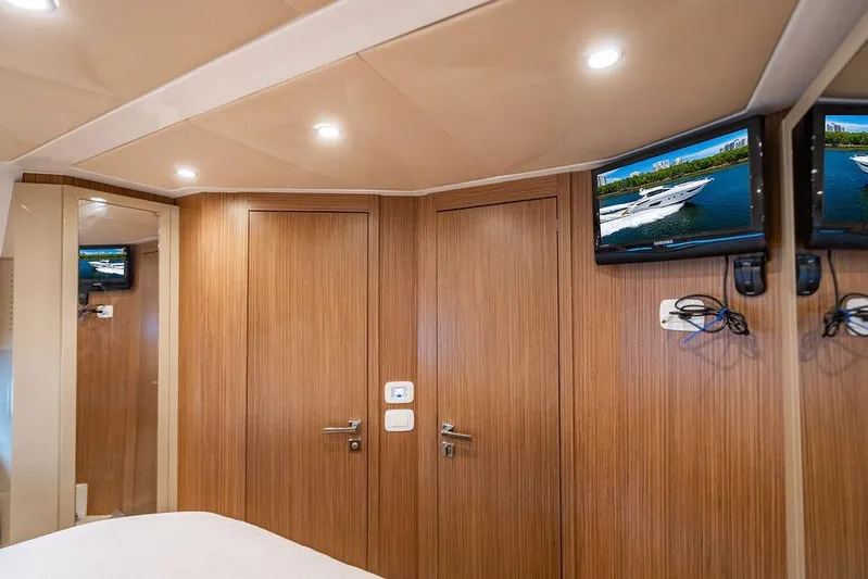 Endurance Yacht Photos Pics Luxurious interior of 2016 Azimut Atlantis 50 yacht with wood paneling and mounted TVs.