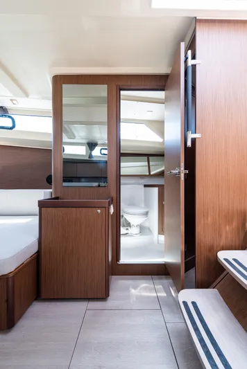  Yacht Photos Pics Interior of 2020 Beneteau Oceanis 41.1 yacht, featuring modern wood finish and compact bathroom.