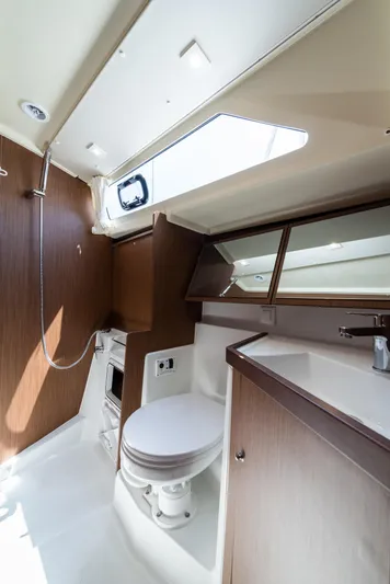  Yacht Photos Pics 2020 Beneteau Oceanis 41.1 yacht bathroom with modern fixtures and wood accents.