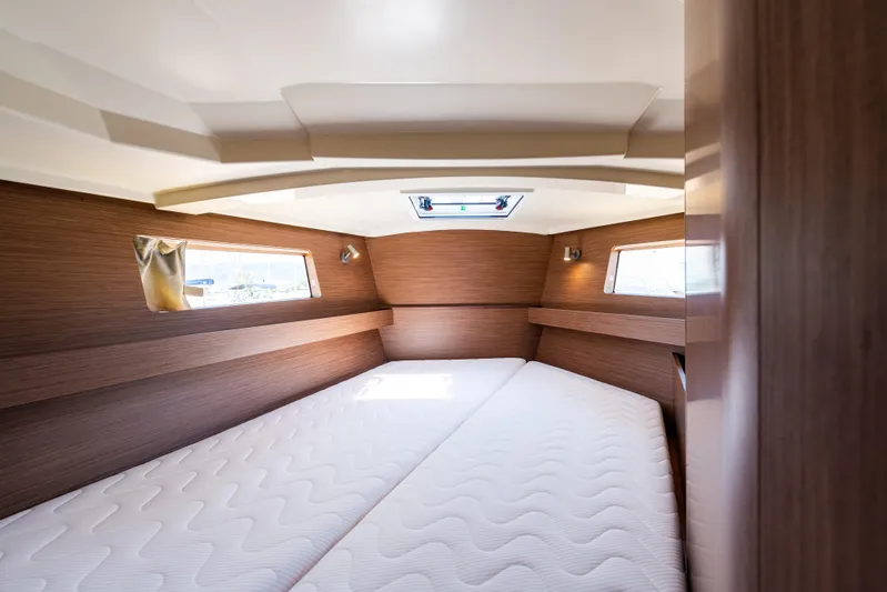  Yacht Photos Pics Interior cabin of 2020 Beneteau Oceanis 41.1 yacht with twin beds and wooden finish.