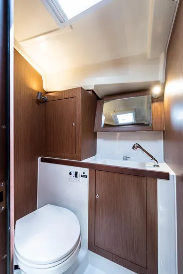  Yacht Photos Pics 2020 Beneteau Oceanis 41.1 yacht bathroom with wood accents and modern fixtures.