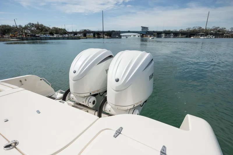  Yacht Photos Pics 2023 Grady-White Freedom 285 boat with dual outboard engines on calm water.