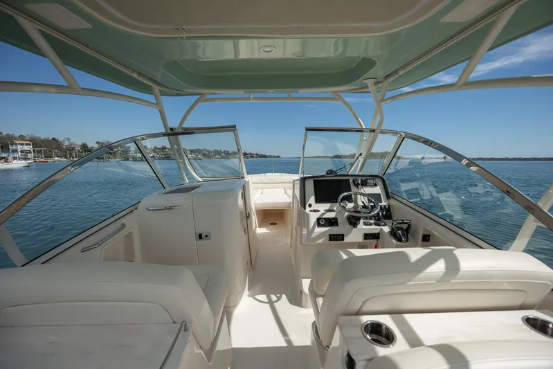  Yacht Photos Pics 2023 Grady-White Freedom 285 boat interior with helm, seating, and ocean view.