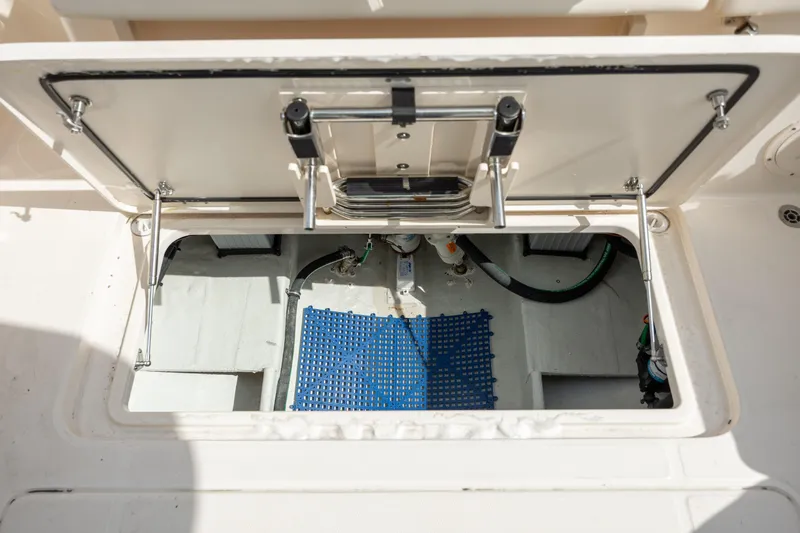  Yacht Photos Pics Open hatch of 2023 Grady-White Freedom 285 boat, showing interior storage compartment.