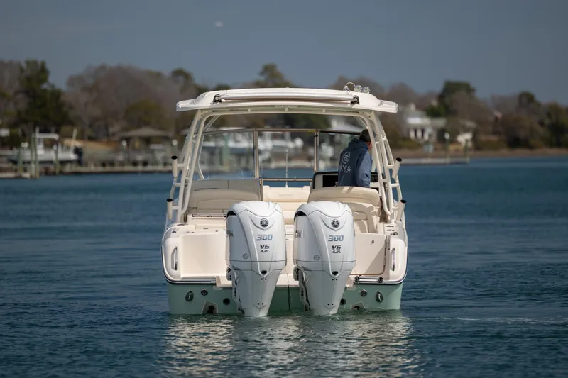  Yacht Photos Pics 2023 Grady-White Freedom 285 boat with dual engines on calm water.