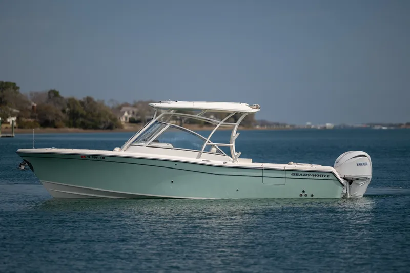 Yacht Photos Pics 2023 Grady-White Freedom 285 boat on calm water, side view.