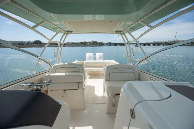  Yacht Photos Pics 2023 Grady-White Freedom 285 boat interior with spacious seating and scenic water view.