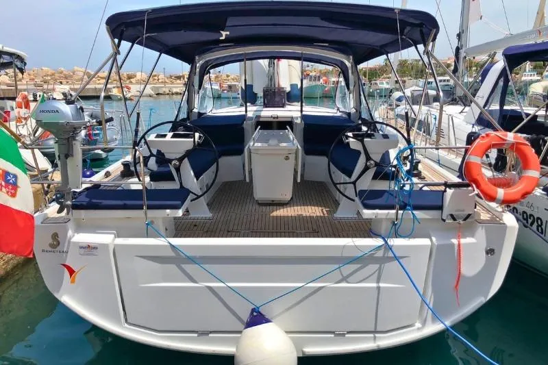  Yacht Photos Pics 2019 Beneteau Oceanis 46.1 yacht docked, featuring dual steering wheels and a spacious cockpit.