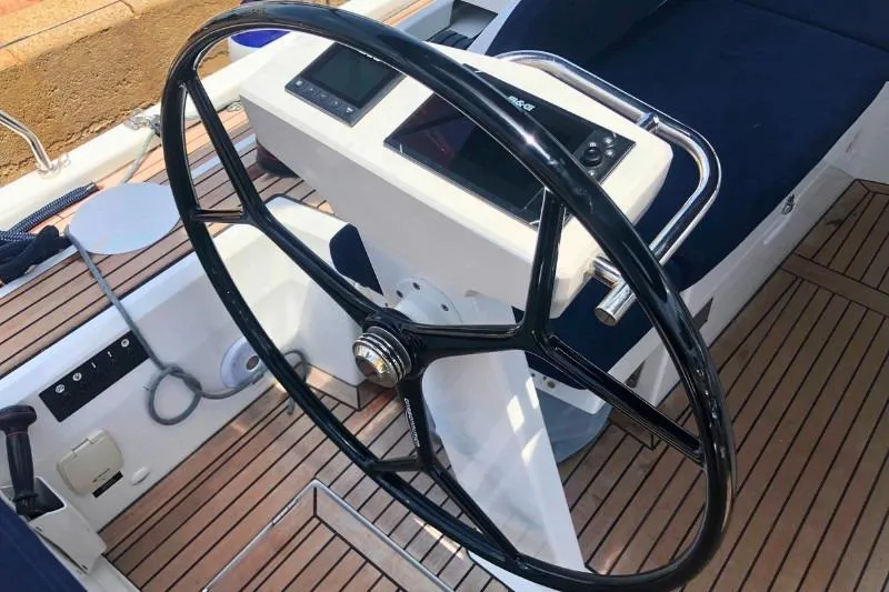  Yacht Photos Pics Steering wheel of 2019 Beneteau Oceanis 46.1 yacht with teak deck and navigation instruments.