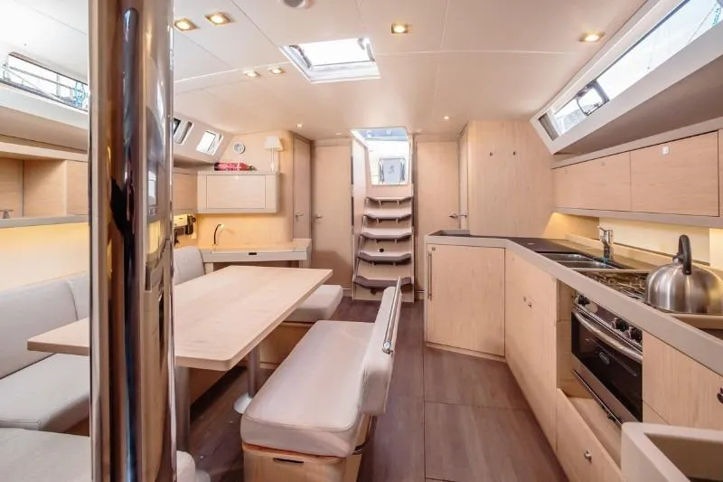  Yacht Photos Pics Luxurious interior of 2019 Beneteau Oceanis 46.1 yacht with modern kitchen and dining area.