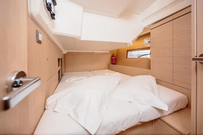  Yacht Photos Pics Cozy cabin interior of 2019 Beneteau Oceanis 46.1 yacht with comfortable bedding.
