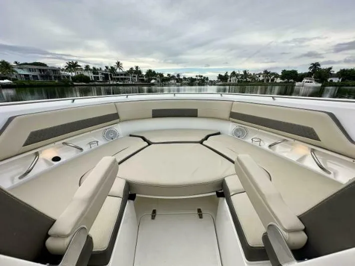 Yacht Photos Pics 2019 Pursuit DC 325 Dual Console boat interior with spacious seating and scenic waterfront view.
