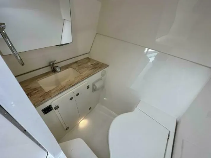  Yacht Photos Pics 2019 Pursuit DC 325 Dual Console boat bathroom with sink, countertop, and toilet.